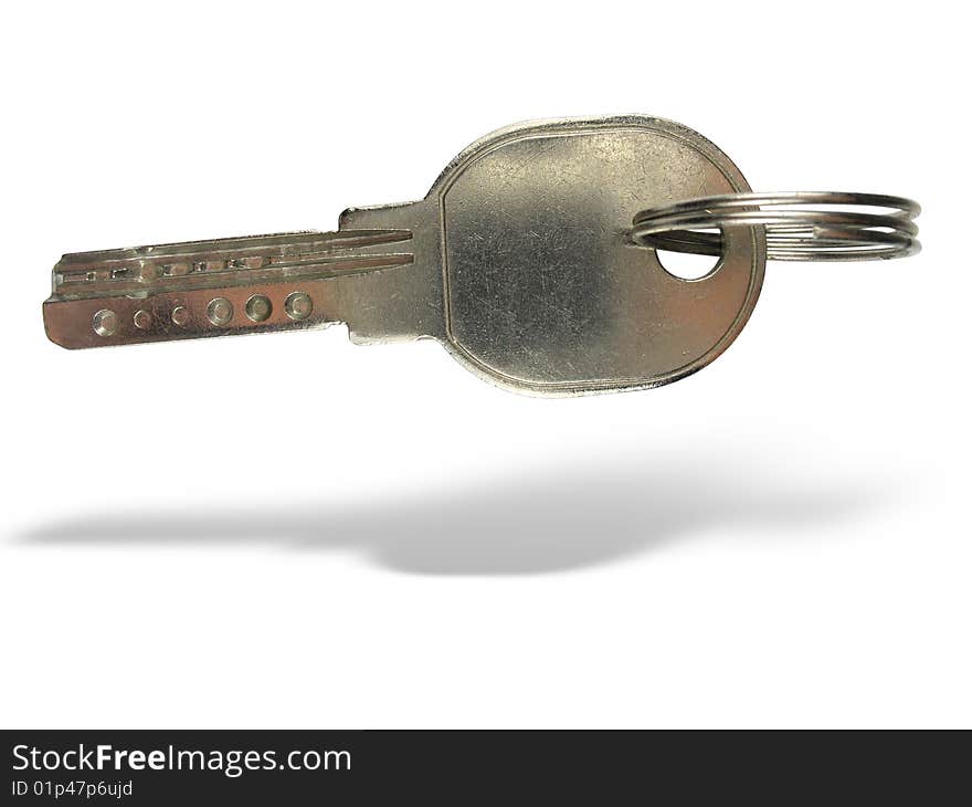 Metallic key with ring and shadow isolated over white background