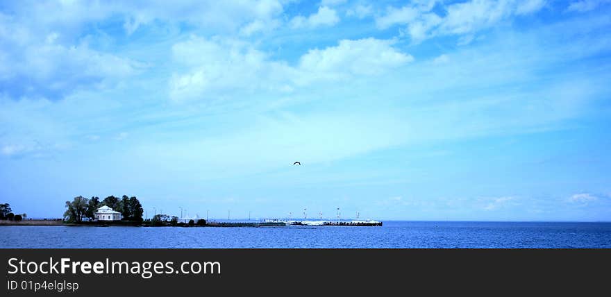 Landscape of sandy island against the blue sky and a water surface. Landscape of sandy island against the blue sky and a water surface