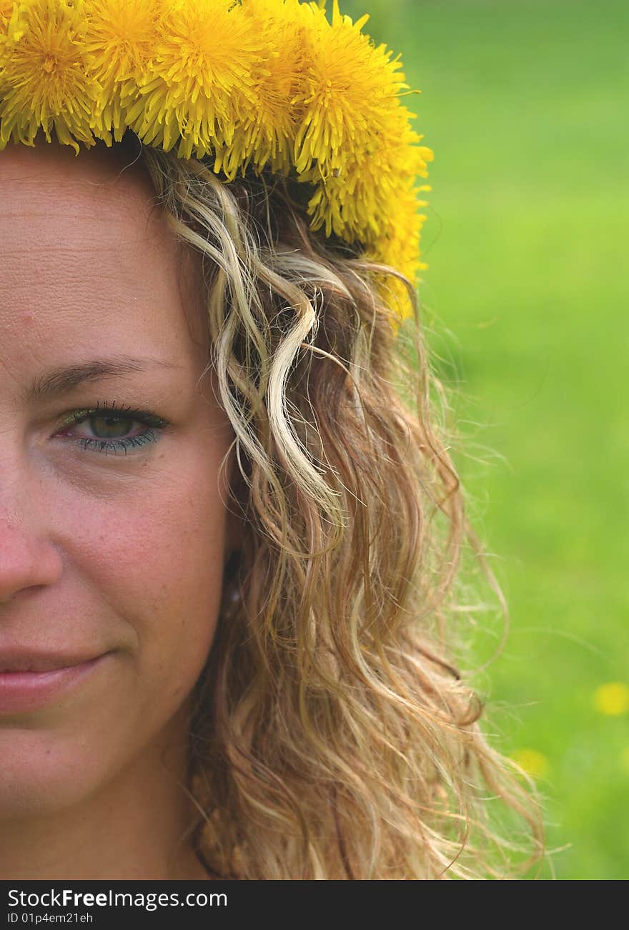 Curly girl portrait with dandelion chain on head