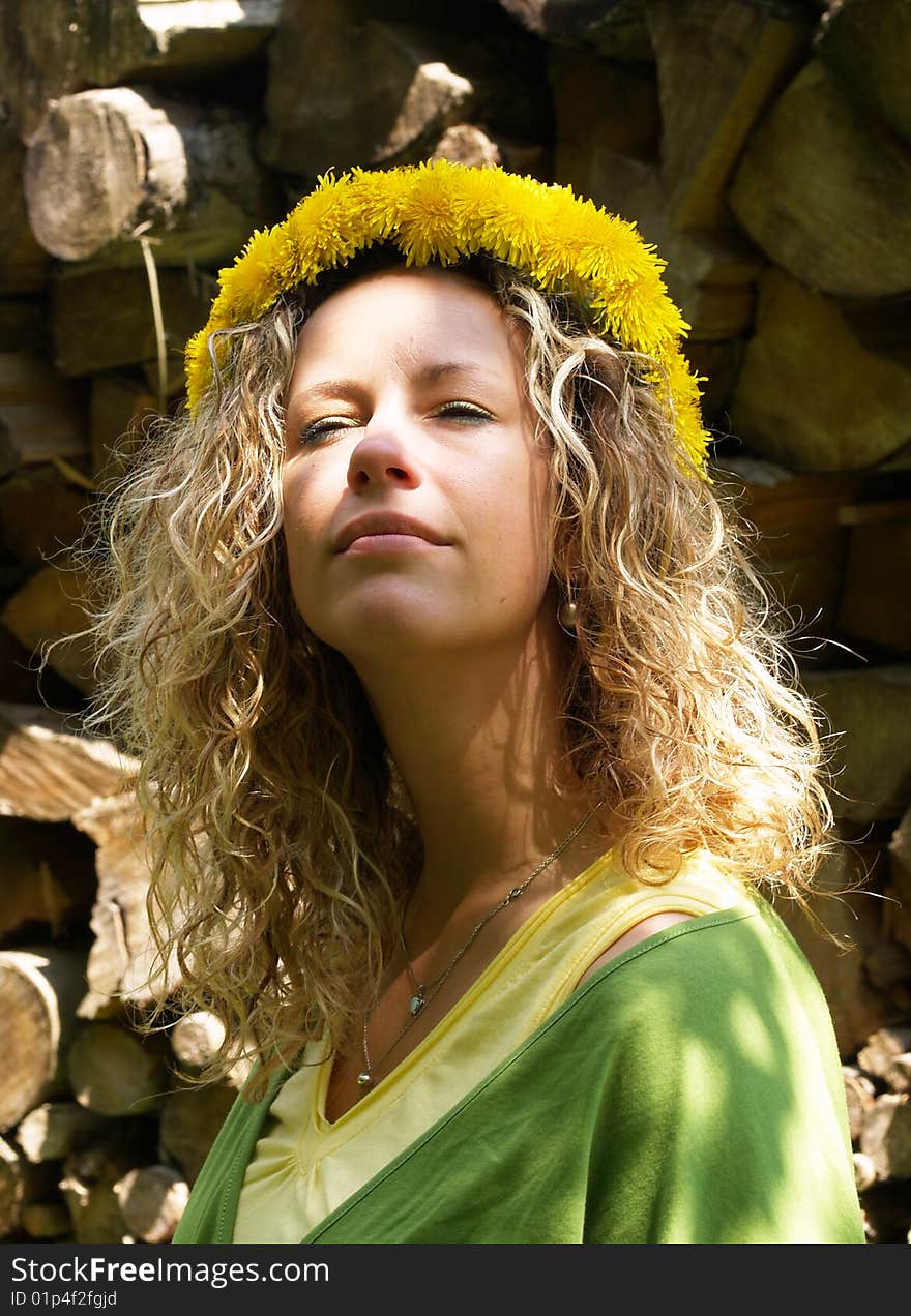 Curly girl with dandelion chain