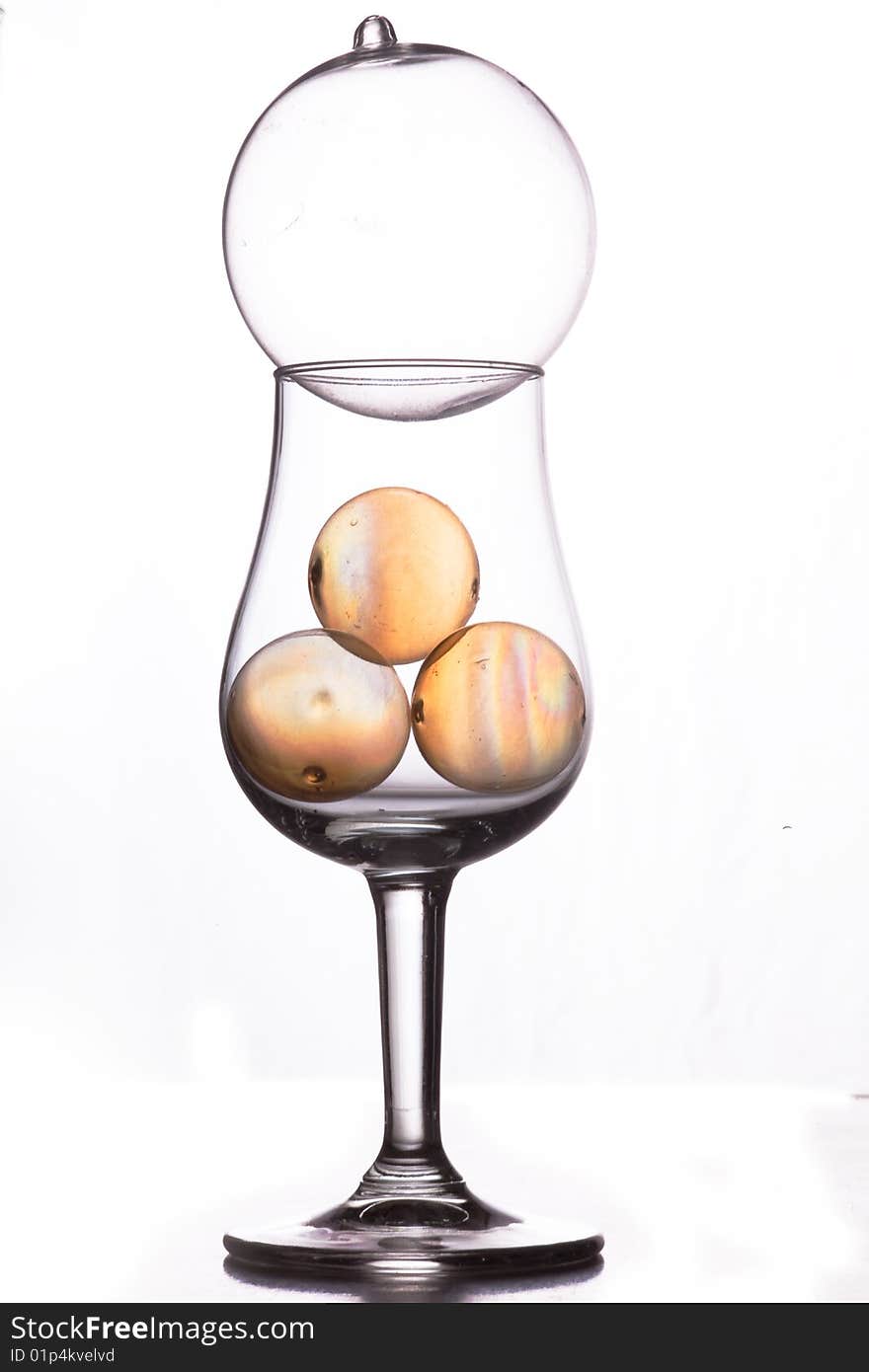 Still life of glass in studio transparent globes in small wine glass. Still life of glass in studio transparent globes in small wine glass