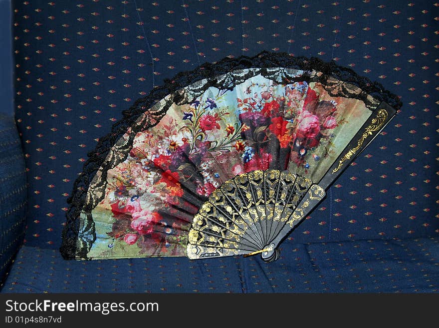 Colourful floral design on fabric hand fan. Colourful floral design on fabric hand fan