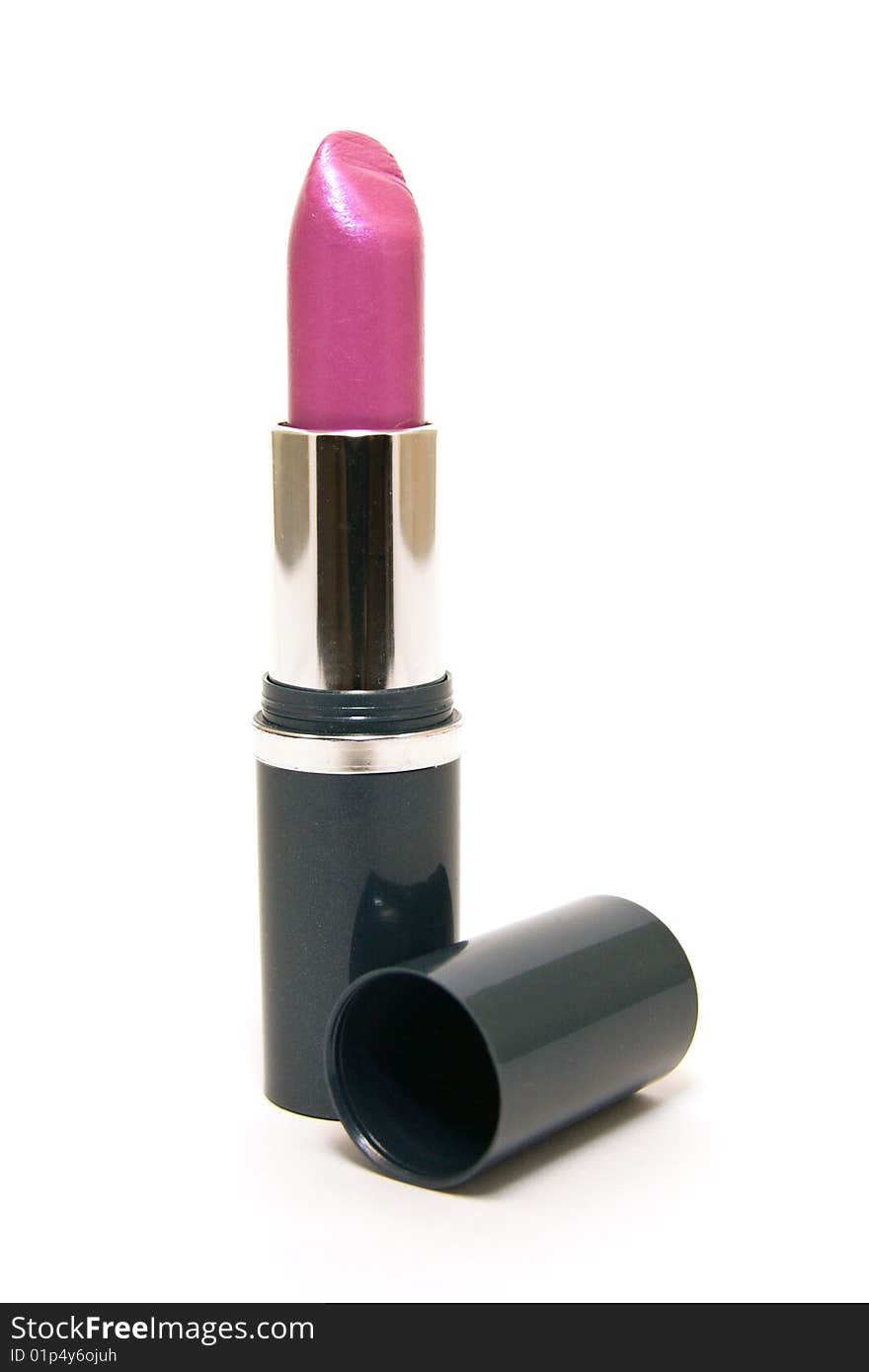 Single pink lipstick with the lid on a white background. Single pink lipstick with the lid on a white background