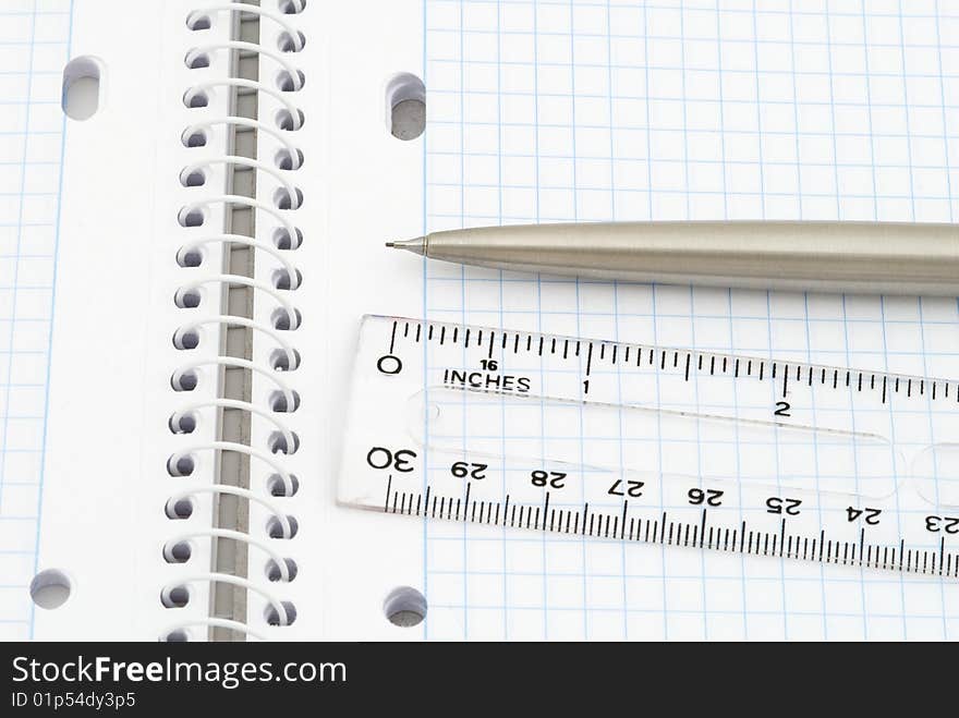 Business background with spiral notebook, pencil and ruler