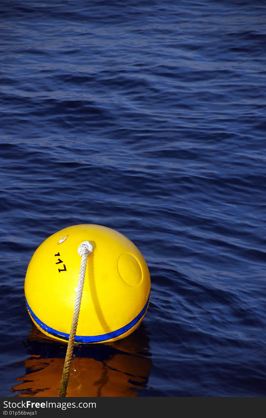 A striking yellow buoy in the waters around the Similans, South-East Asia