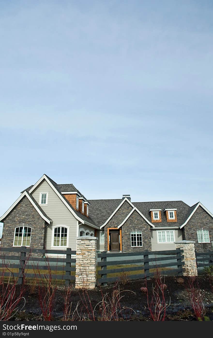 New home exterior with a blue sky background. New home exterior with a blue sky background