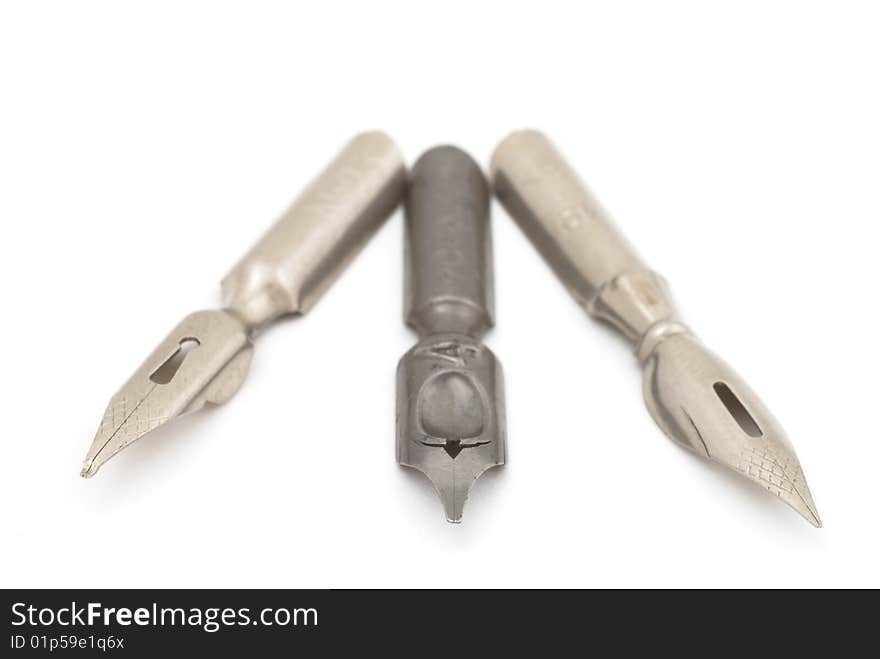 Old silver and steel fountain pens. Selective focus