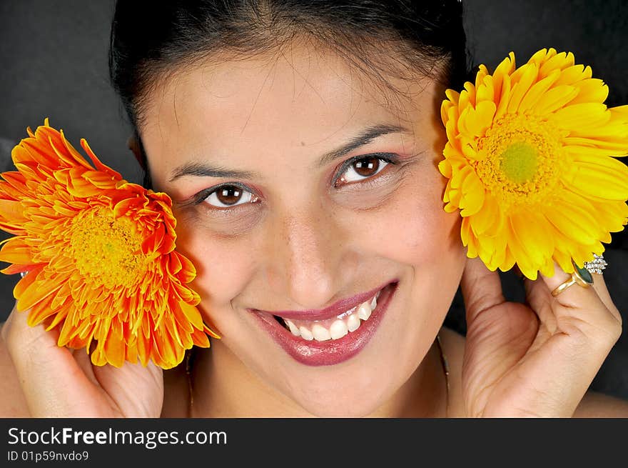 Girl with flowers posing in studio.