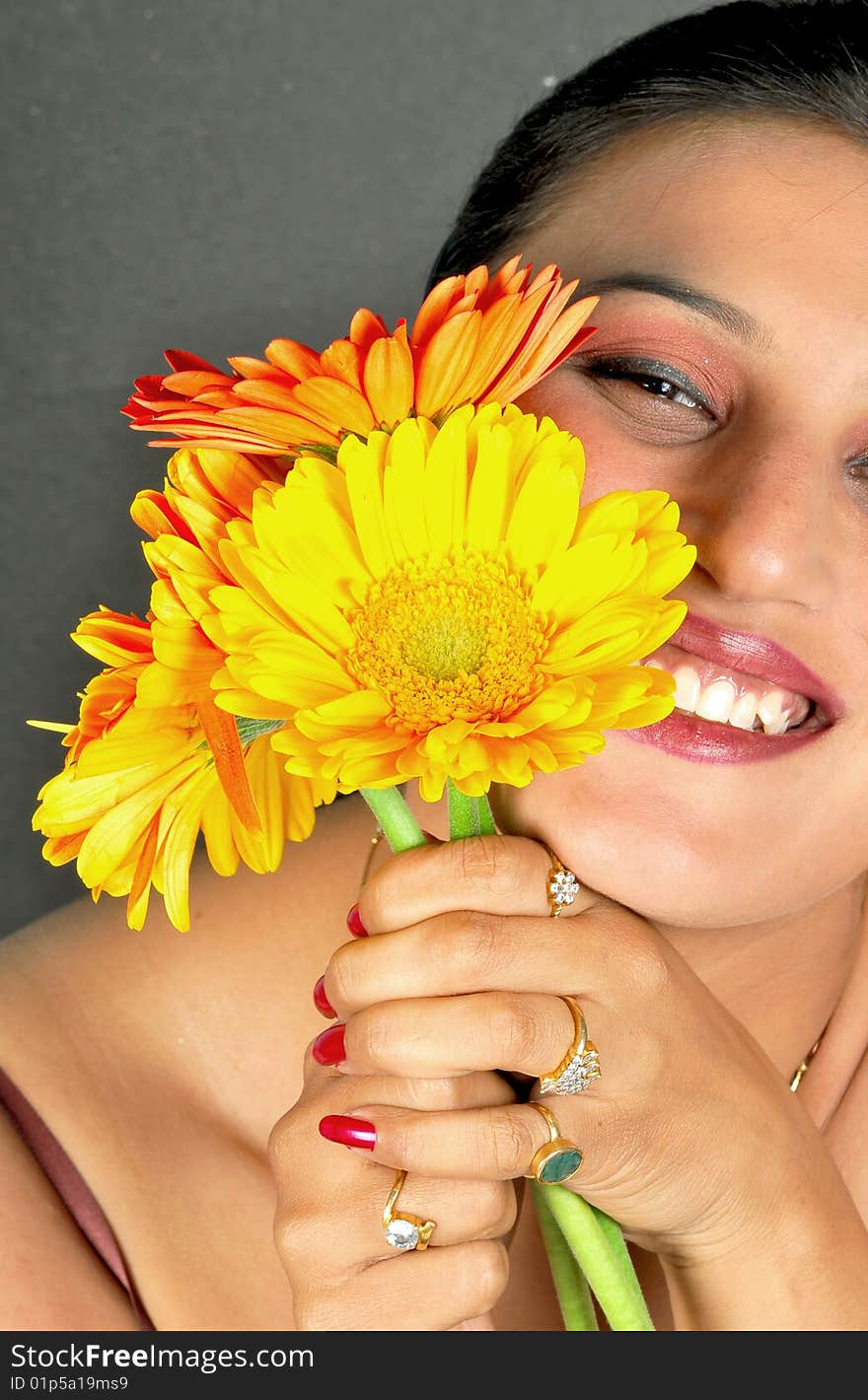 Girl with flowers posing in studio.