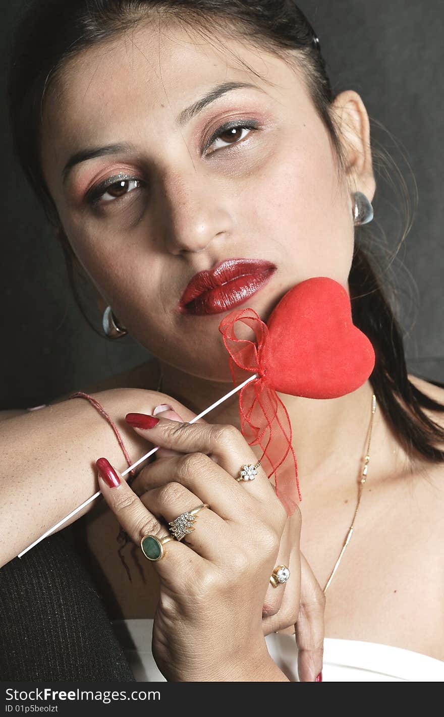 Girl with heart posing in studio.