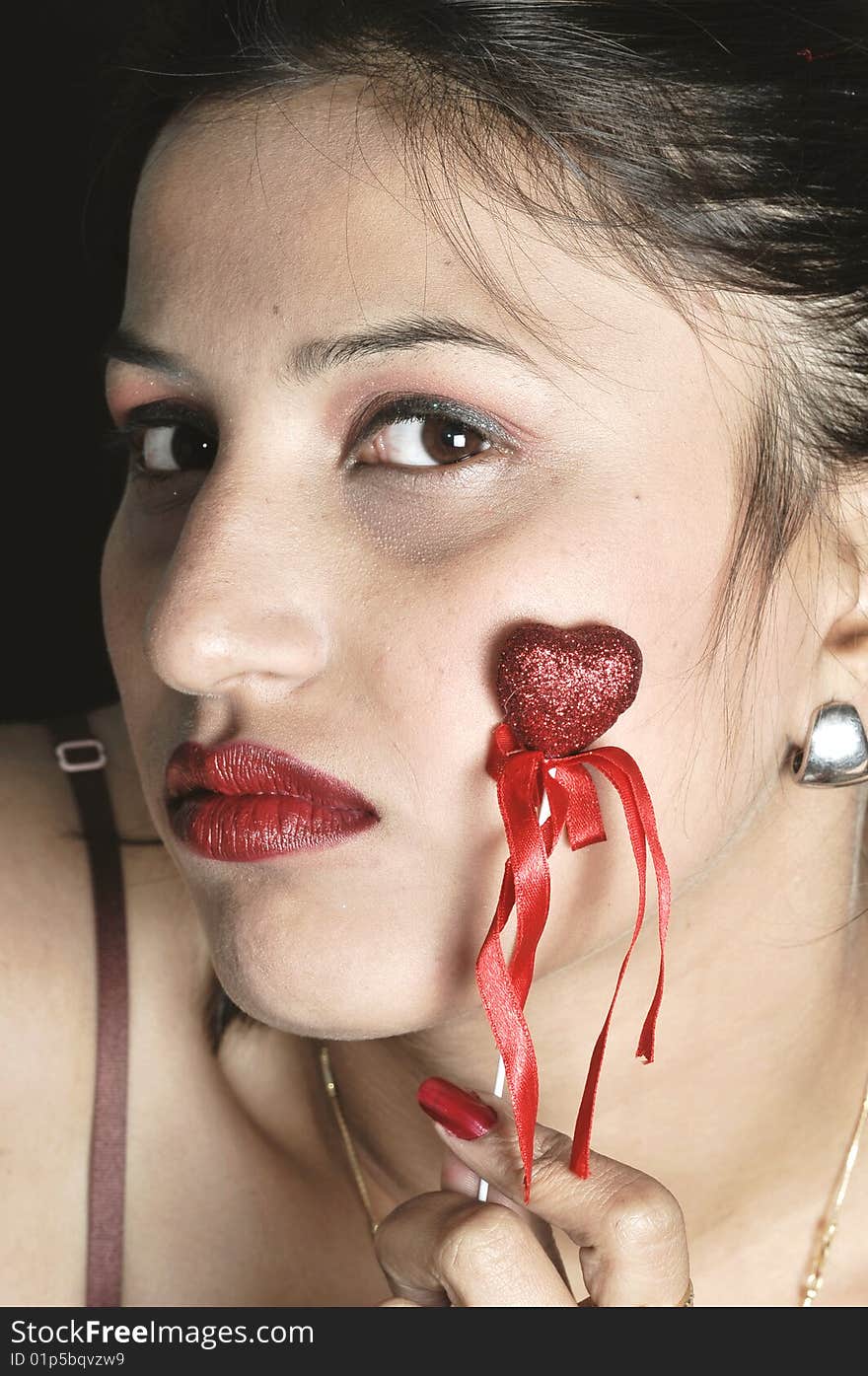 Girl with heart posing in studio.