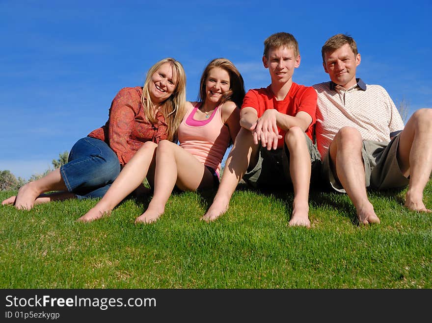 Colorado family posing on grass area. Colorado family posing on grass area