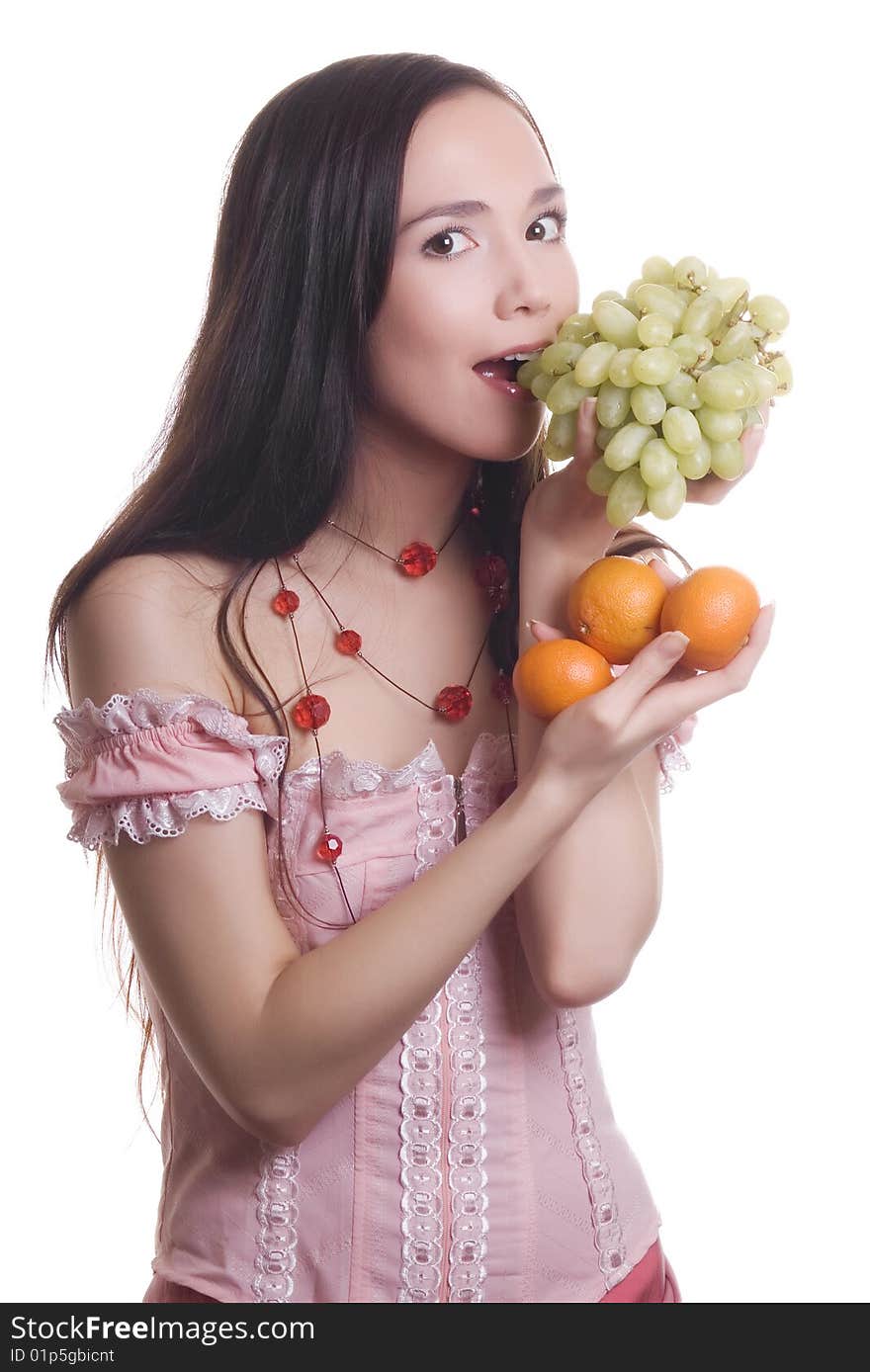 Brunette Beautiful smile with fruit tangerines and grapes