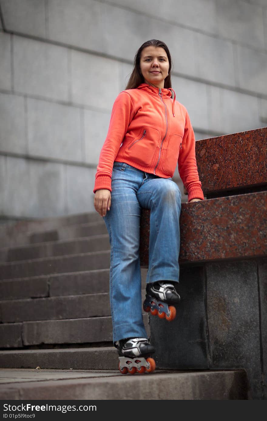 Portrait of rollerskating girl on granite stairs - shallow DOF