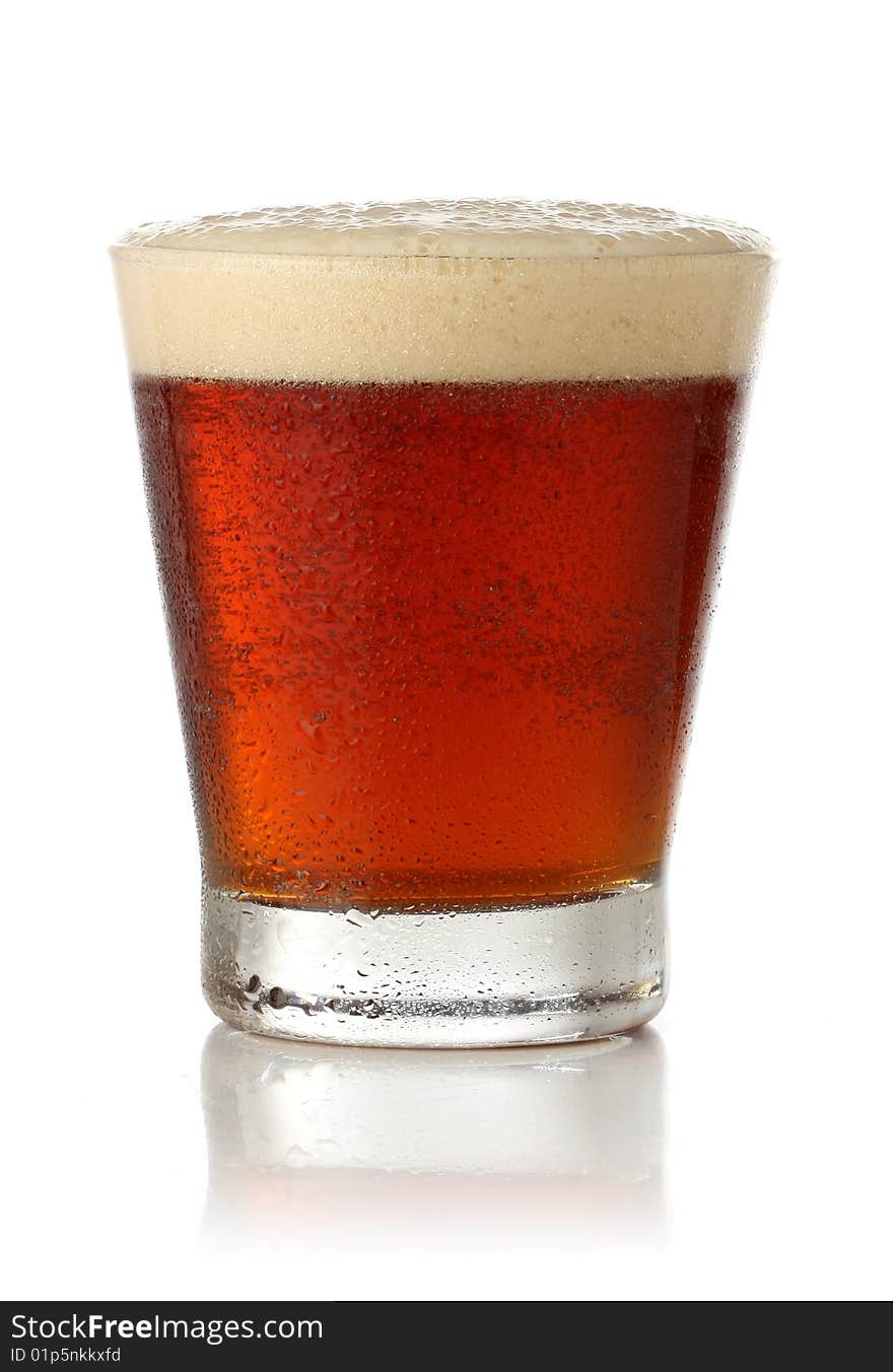 Cold glass of beer over white background