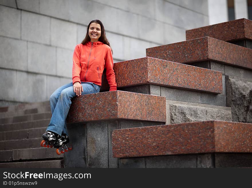 Portrait of rollerskating girl on granite stairs - shallow DOF