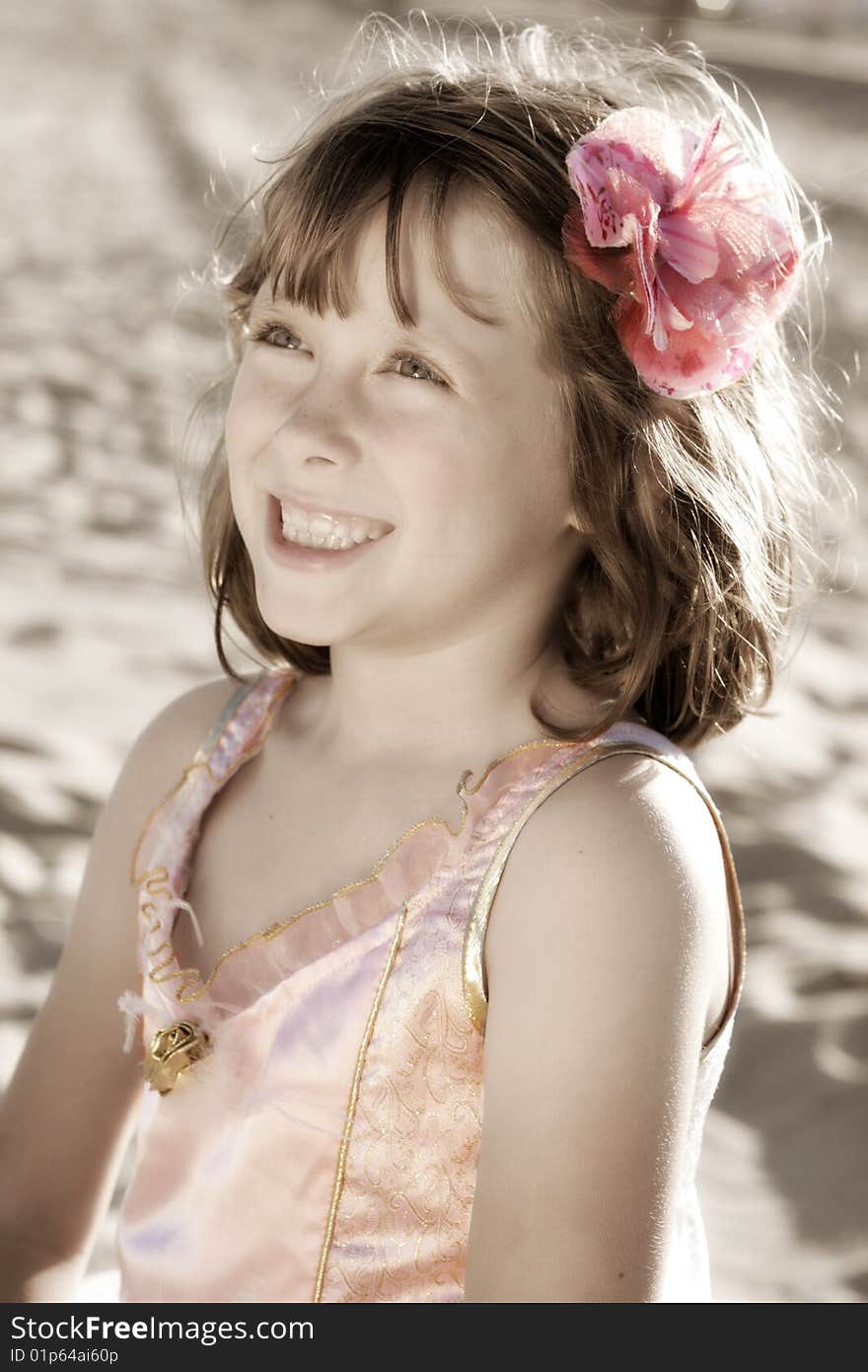 A portrait view of a smiling young 7-year old girl in a fairy ballerina dress or costume. A portrait view of a smiling young 7-year old girl in a fairy ballerina dress or costume.