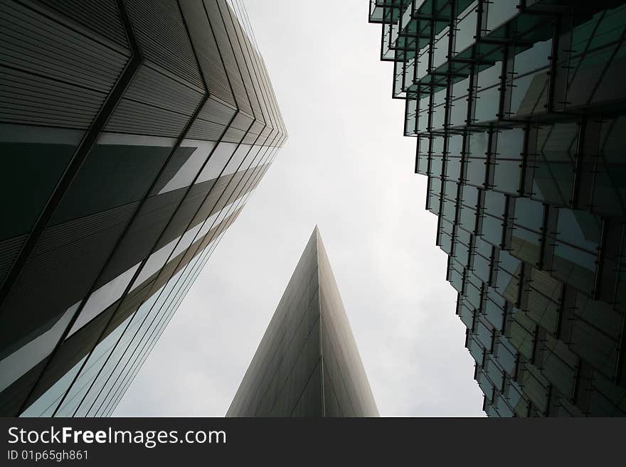 A photo of office buildings meeting at a corner, making a striking contrast of patterns