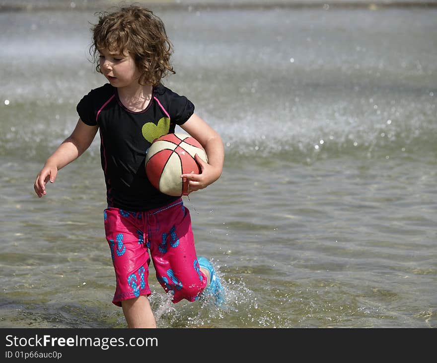 Child playing in pool.