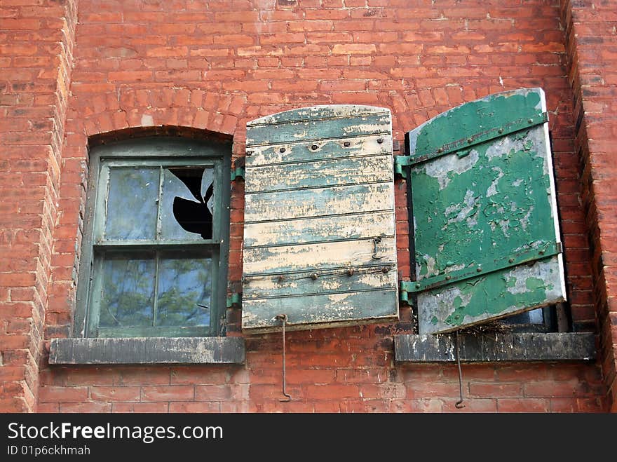 Old grungy brick building with broken windows