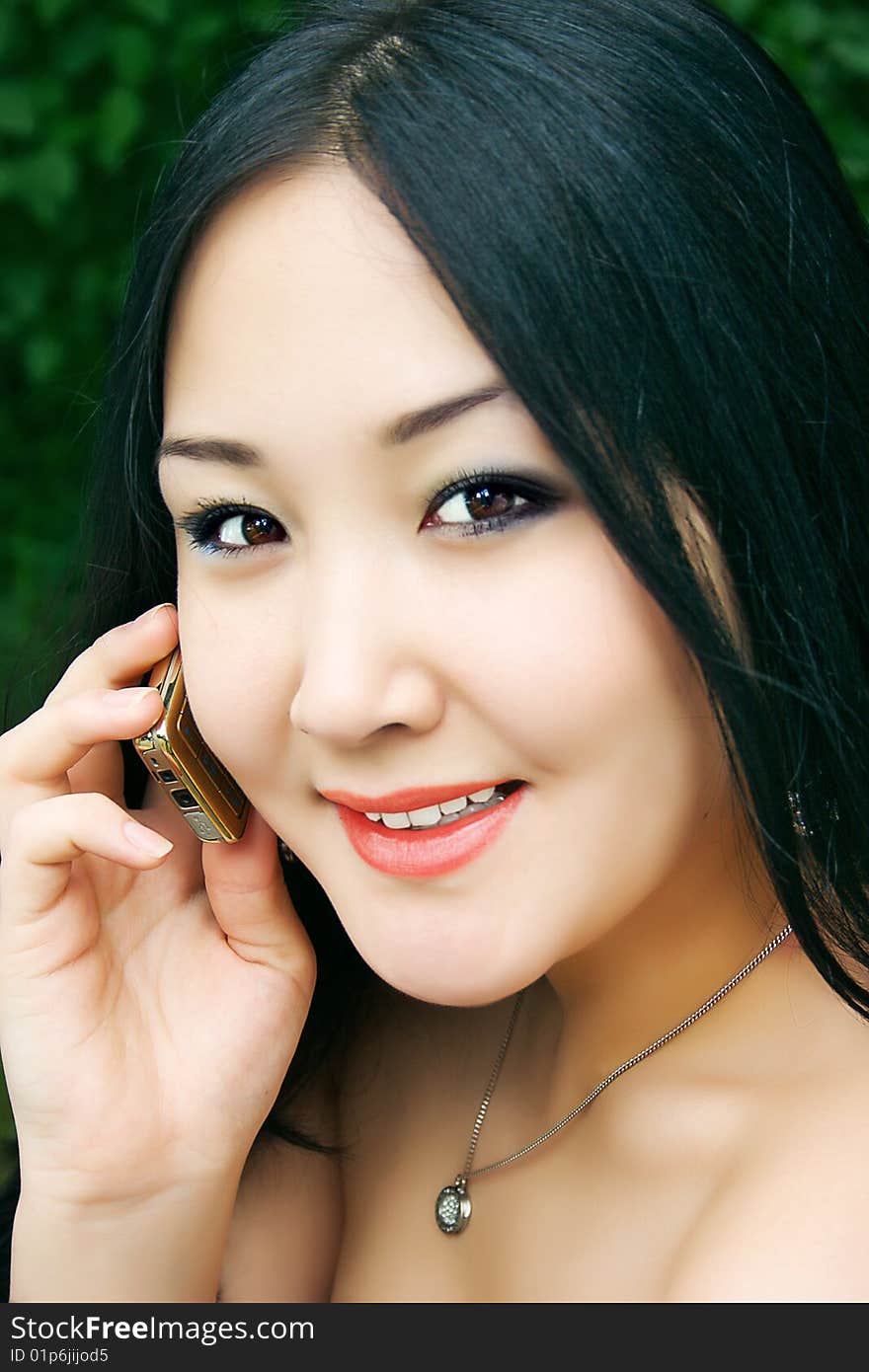 Beautiful asian girl with cellphone. Beautiful asian girl with cellphone