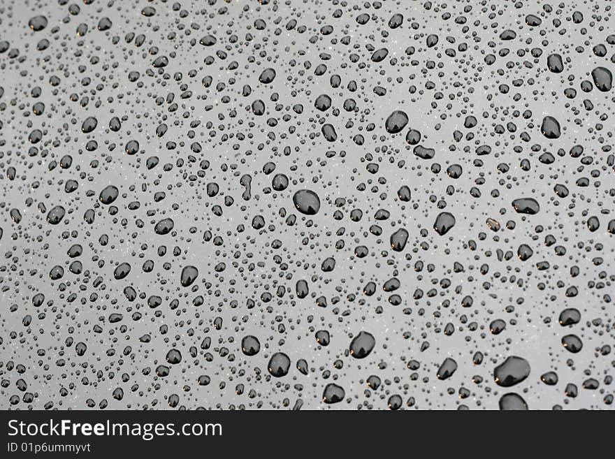 Water drops on the black smooth background