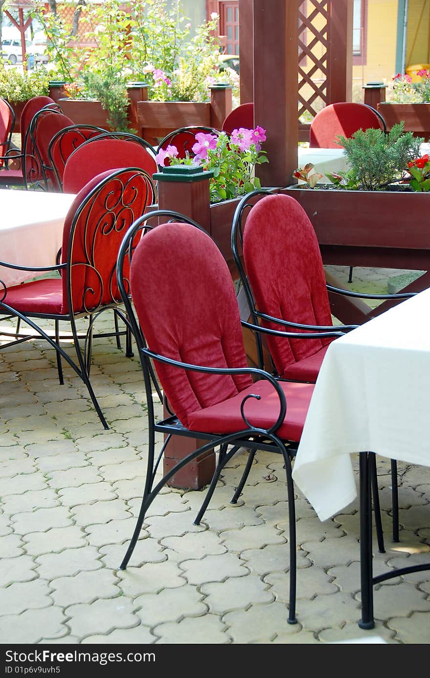 Restaurant terrace with metallic chairs and tables outdoor