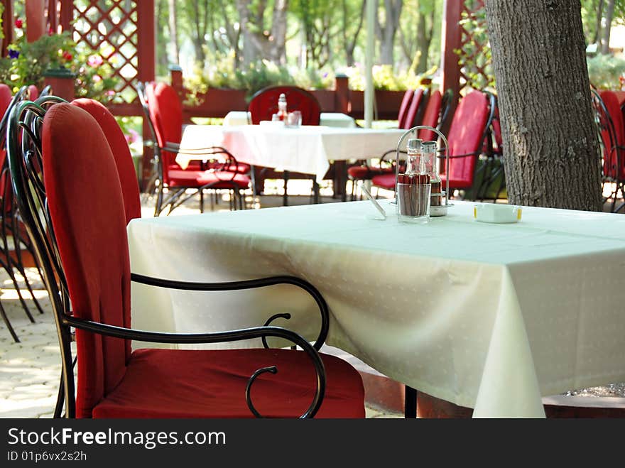 Restaurant terrace with metallic chairs and tables outdoor