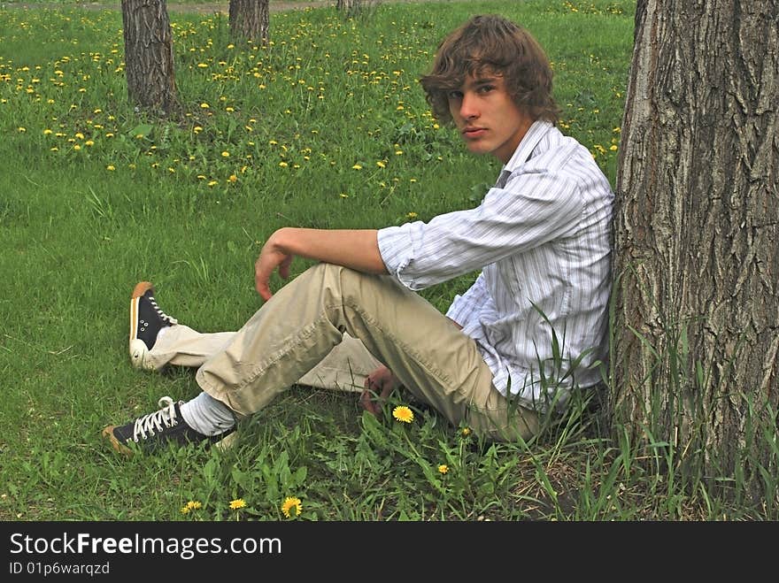 The young man near the tree. The young man near the tree