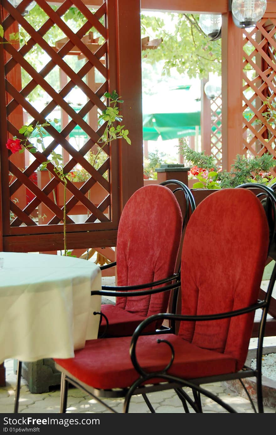 Restaurant terrace with metallic chairs and tables outdoor