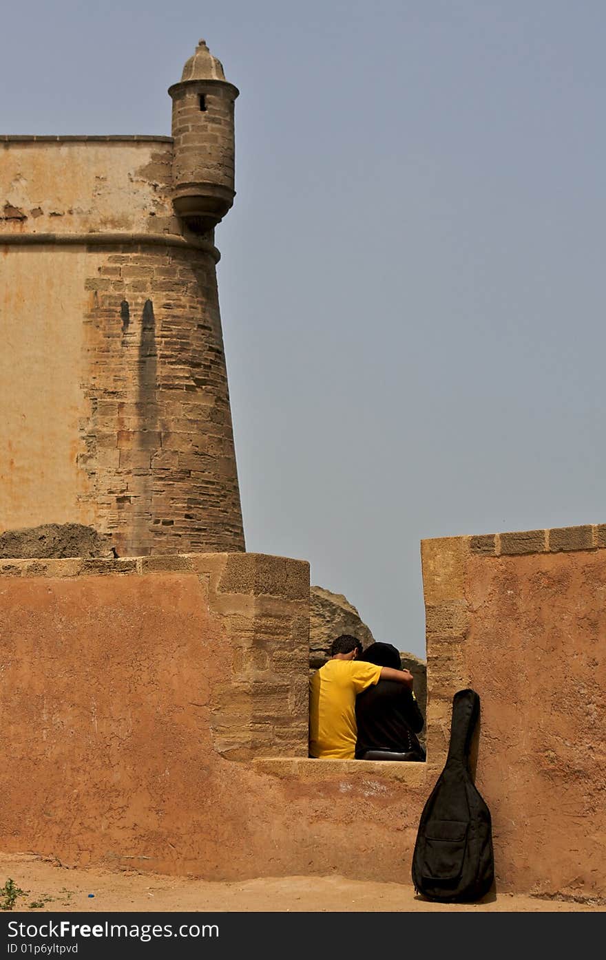 Couple of lovers sitting at old wall. Couple of lovers sitting at old wall