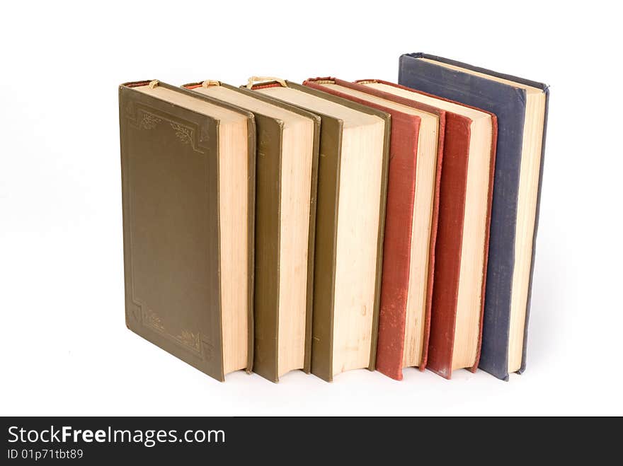 Old books in a row isolated on white