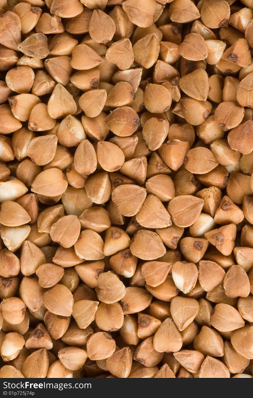 Dried brown buckwheat, texture, background. Closeup. Dried brown buckwheat, texture, background. Closeup