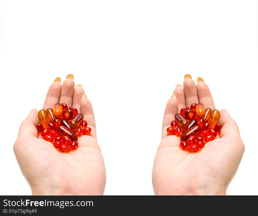 Medicine capsules in human hands isolated on white