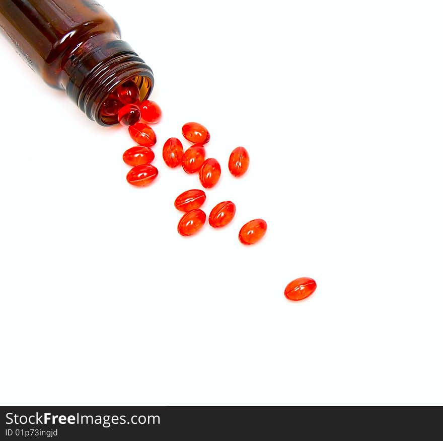 Glass Small bottle with medicine capsules isolated on white