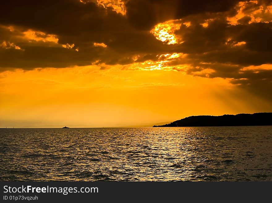 This is a picture of the rising sun at the Balaton Lake in Hungary. This is a picture of the rising sun at the Balaton Lake in Hungary.