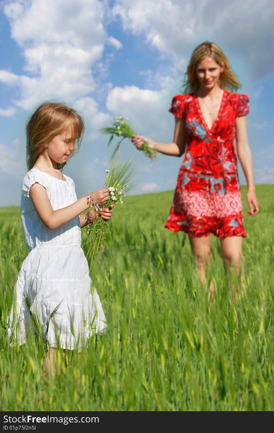 Mother and daughter in field