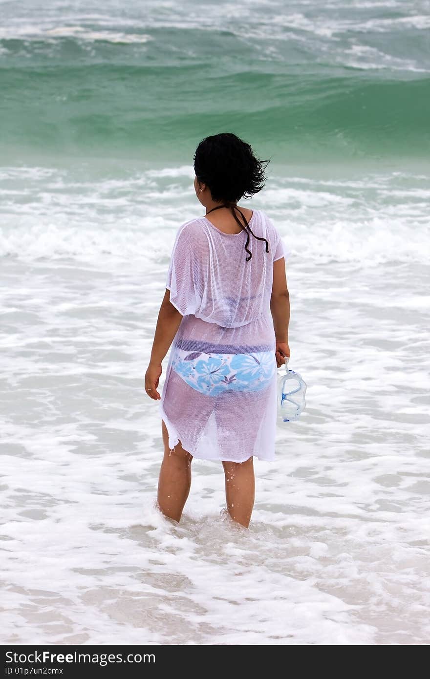 Girl walking in the water