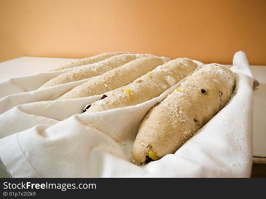 Five baguettes ready for the oven in a restaurant kitchen