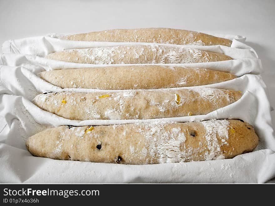 Five baguettes ready for the oven in a restaurant kitchen