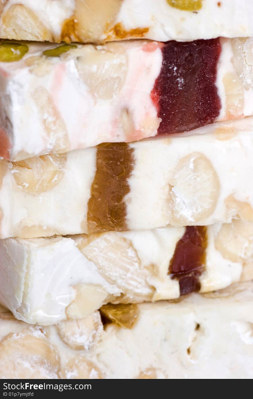 Close-up pieces of sliced delicious nougat from Cassis. Extreme close-up macro. Shallow depth of field. Close-up pieces of sliced delicious nougat from Cassis. Extreme close-up macro. Shallow depth of field.