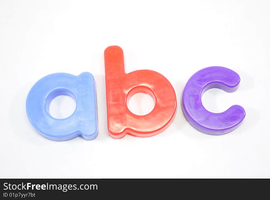 Refrigerator magnets spell out ABC on a white background. Refrigerator magnets spell out ABC on a white background.