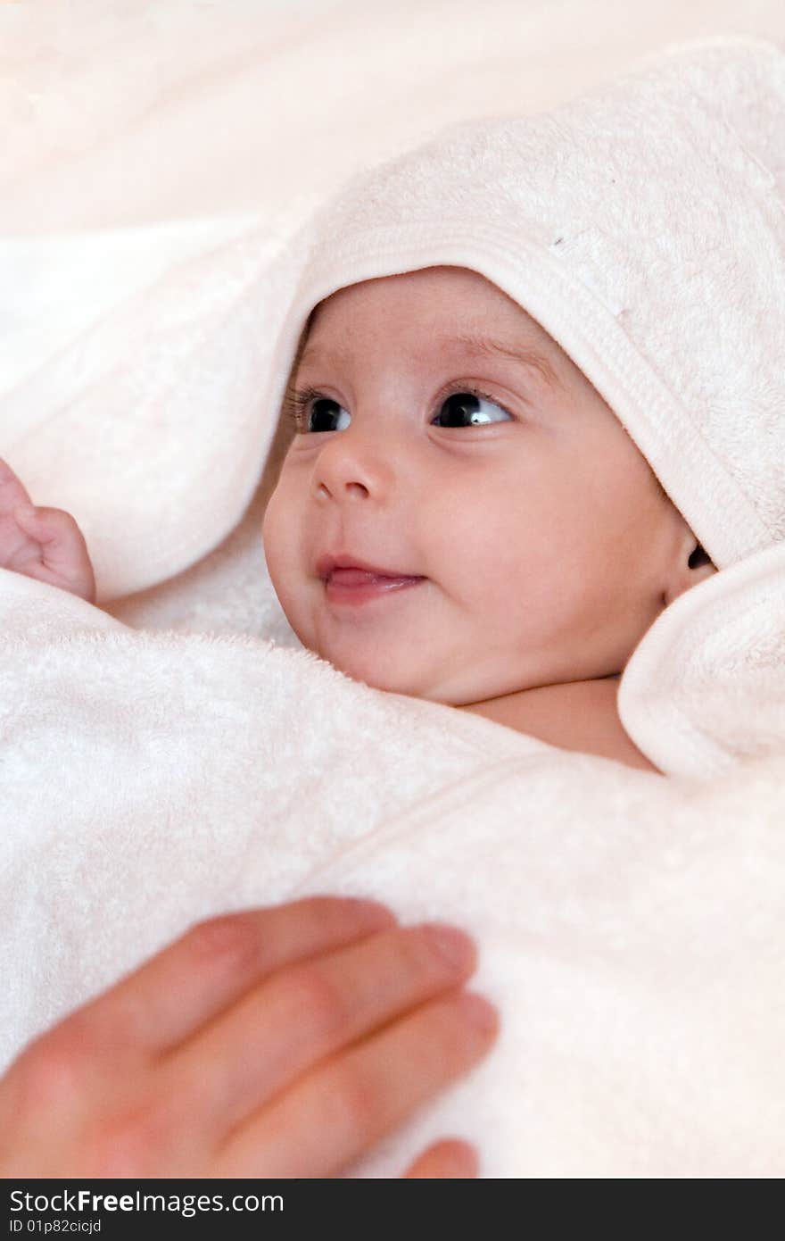 Three-month old baby girl in towel