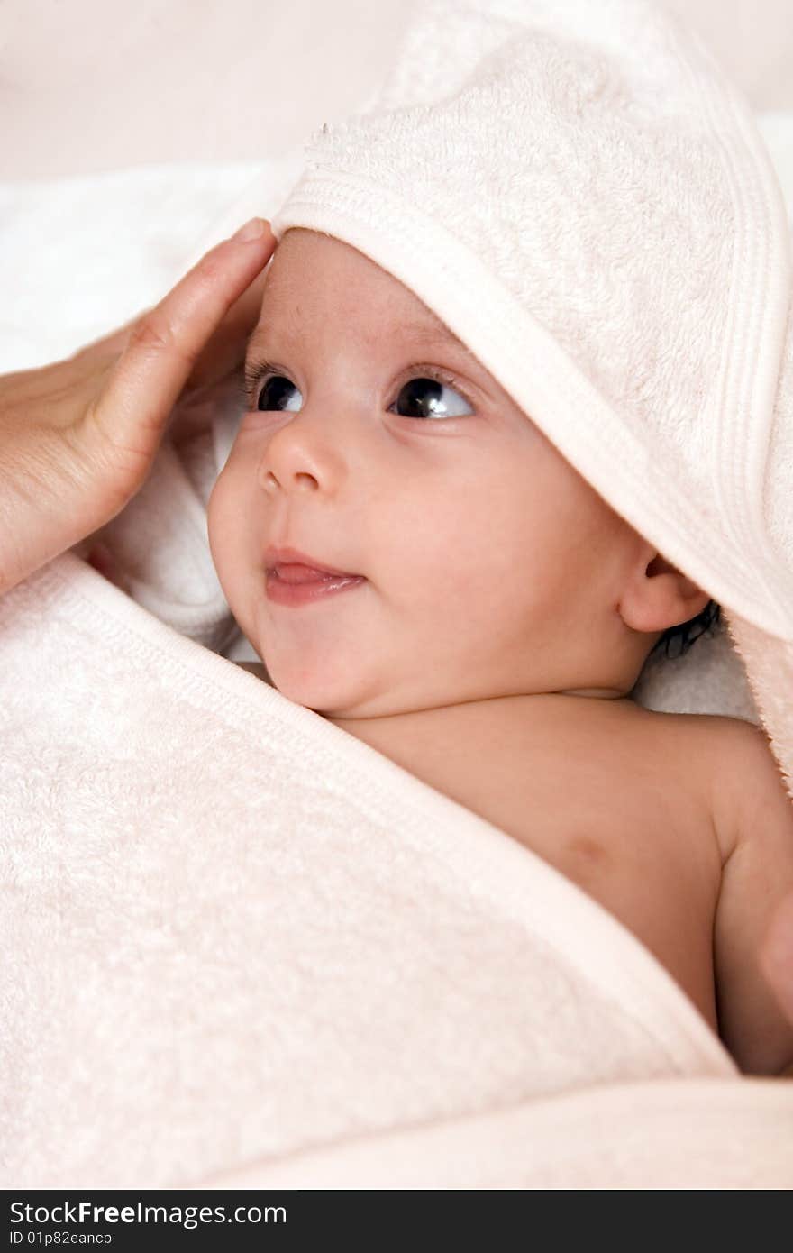 Three-month old baby girl in towel