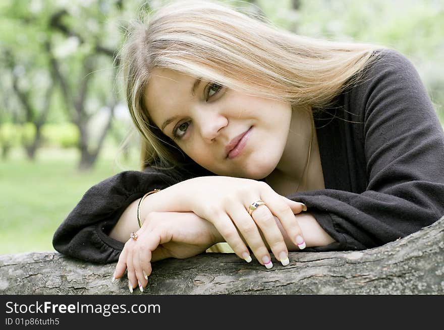 Beautiful young woman outdoors, spring day in park