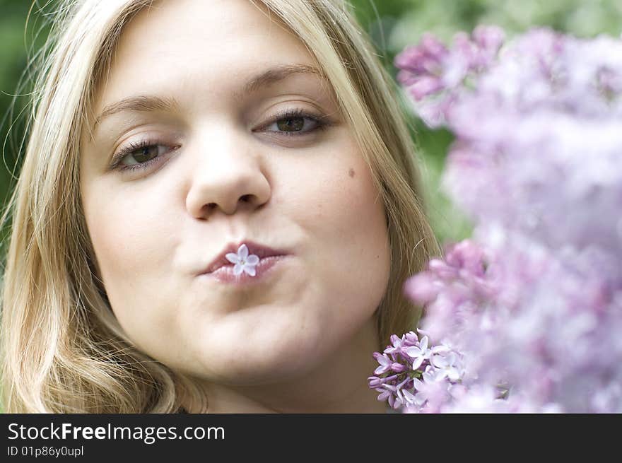 Young woman with happy lilac flower