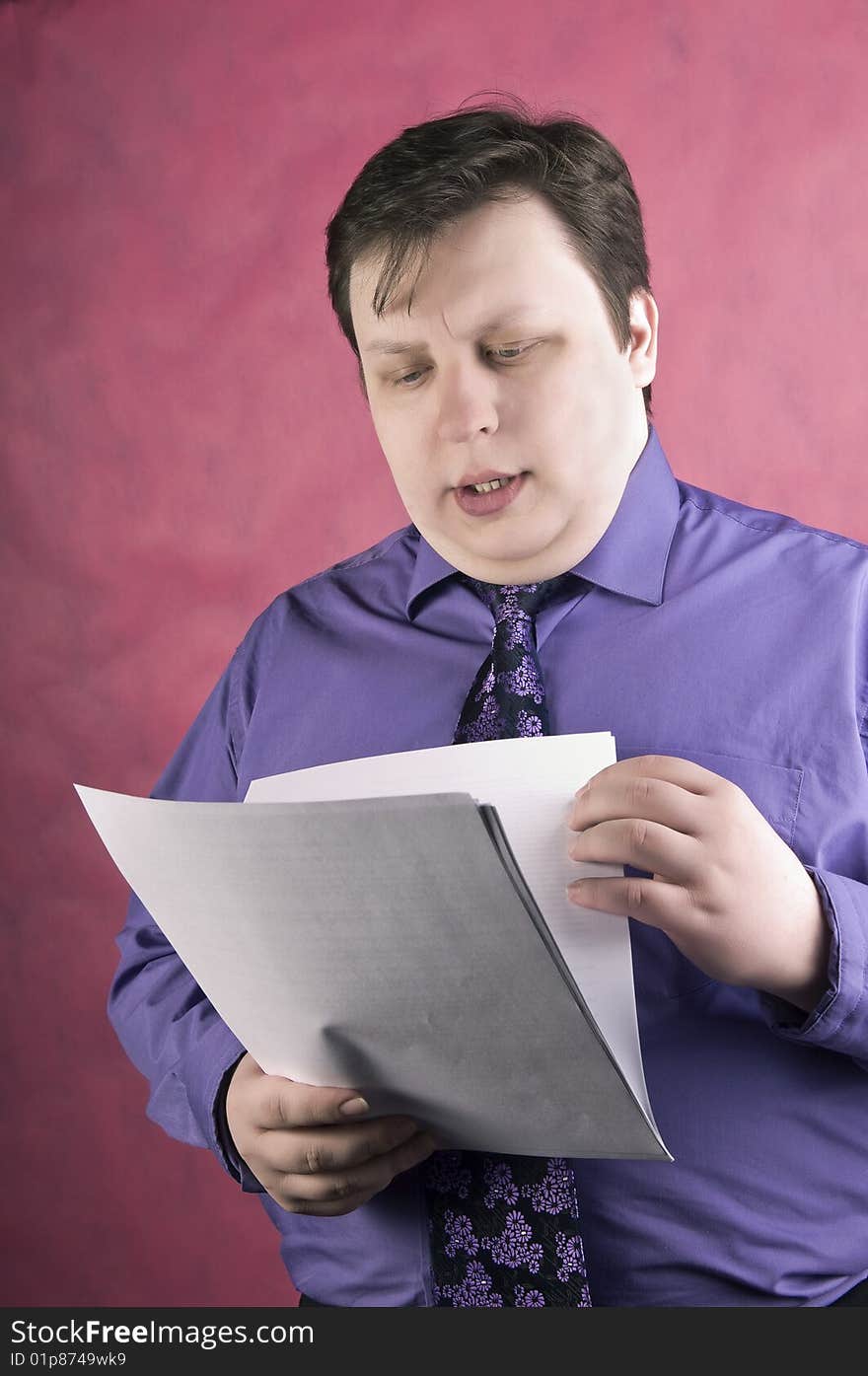 Businessman reading documents, studio shot