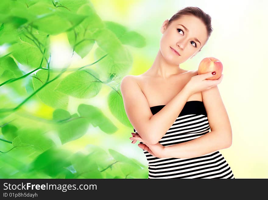 Young woman with apple over green background