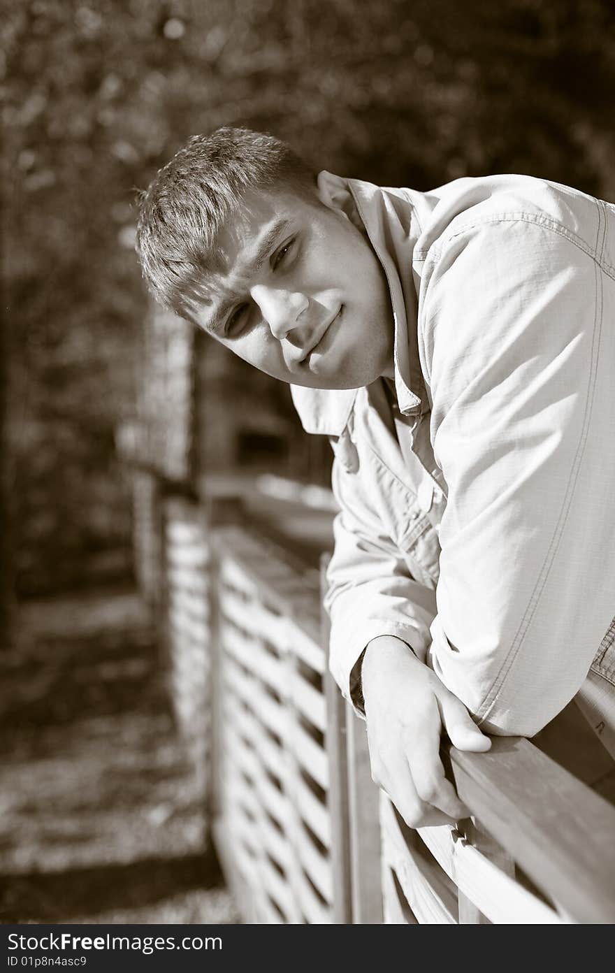 Portrait of young man. Summer day in park