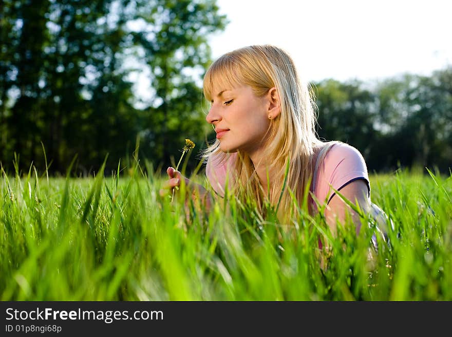 Girl smells a dandelion